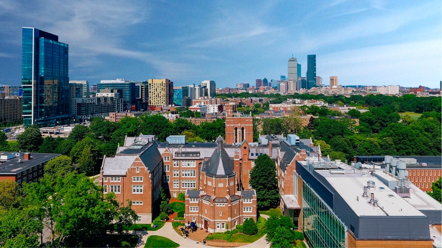 Aerial shot of Emmanuel College campus with Boston skyline in background