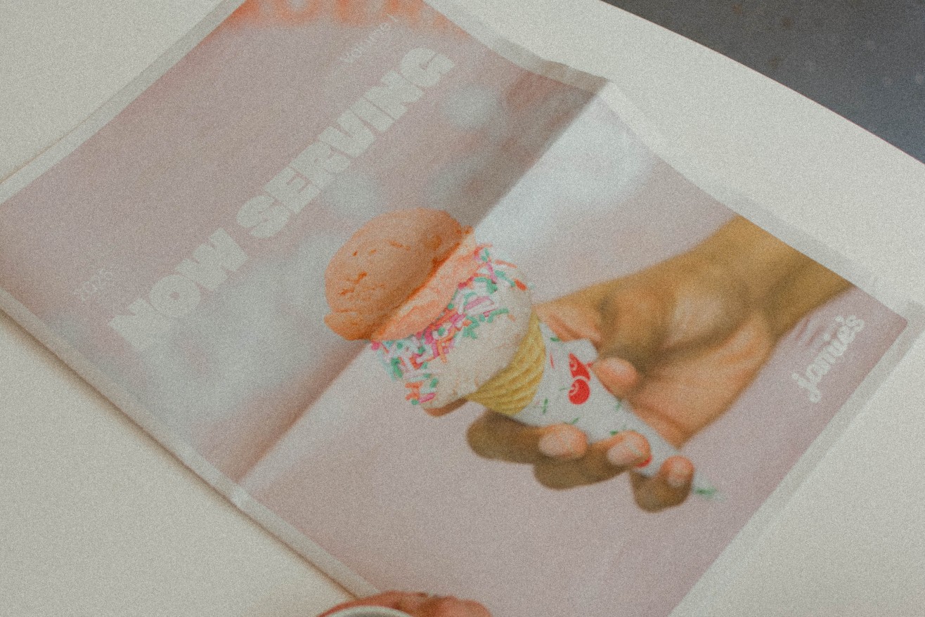 A cup of coffee next to the Jamie's Ice Cream newspaper print